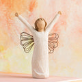 Willow Tree Courage, 6”h hand-painted standing resin angel figure in cream dress with wire wings, both arms upraised, in front of orange painting