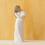 Willow Tree Sanctuary, 6.5”h hand-painted standing resin figure in cream dress, gold-leaf dots encircling her hair and face, holding infant in cream blanket, in front of light orange painting