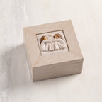 Cream wood box with hinged lid. Inset bas-relief plaque of two seated girls, facing each other.