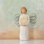 Willow Tree Sweetheart, 5.5" hand-painted resin angel figure in cream dress with wire wings, holding gold-leafed metal wreath of hearts, in front of light blue painting