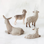Set of two white sheep figurines next to donkey and goat figurine