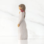 Left side of standing figure in cream dress with cardinal red bird perched on shoulder