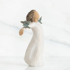 Young brunette girl figurine in white dress arms spread looking up with two blue birds on her arms