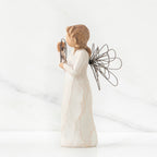 Right side view of angel with tied back brown hair, holding up a circular wire sign that says "thank you"
