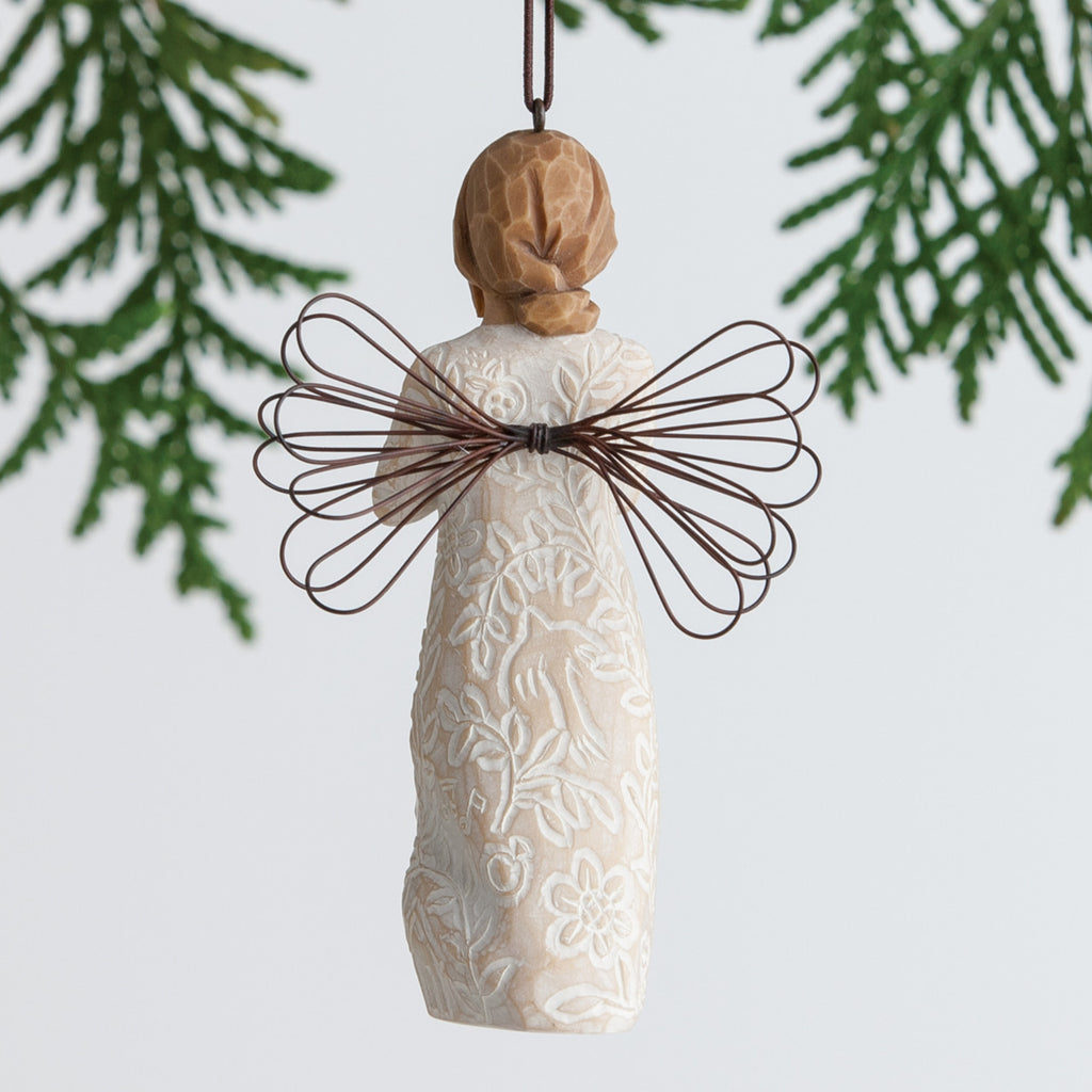 Back view of brunette girl ornament with brown wings hanging from tree branch
