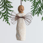 Back view of brunette girl ornament with brown wings hanging from tree branch