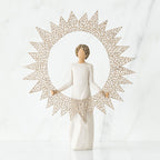 Brunette girl figurine in white dress standing facing forward holding large sun figurine