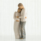Man and woman figurines dressed in white holding the woman's stomach - white background