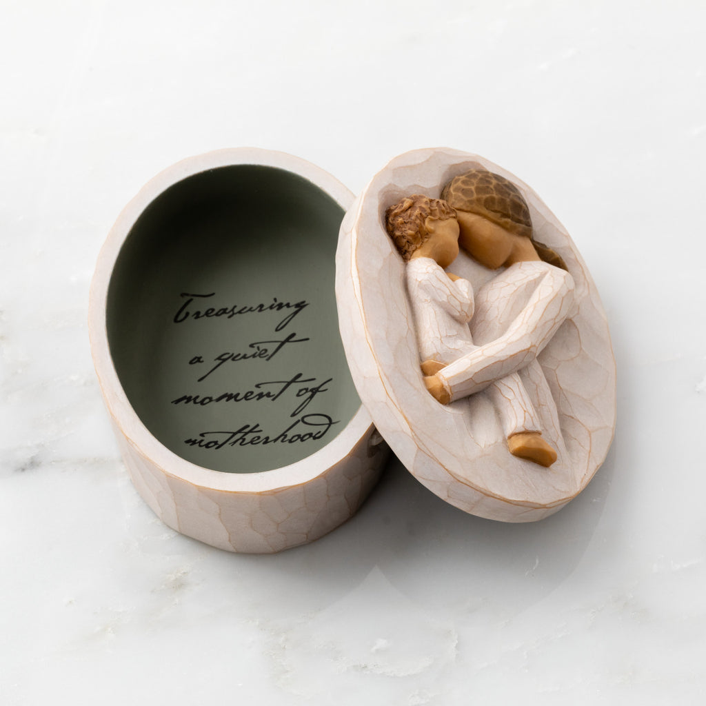 Willow Tree Tenderness Keepsake Box, 3.4" oval x 2.4" W x 1.5" D hand-painted resin box with removable lid. Lid has bas-relief carving of woman holding toddler, touching foreheads, inside of box has sentiment