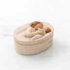 Willow Tree Grandmother Keepsake Box, 3.4" oval x 1.5" h hand-painted resin box with removable lid. Lid has bas-relief carving of older woman in cream dress, holding up baby, inside of box has sentiment