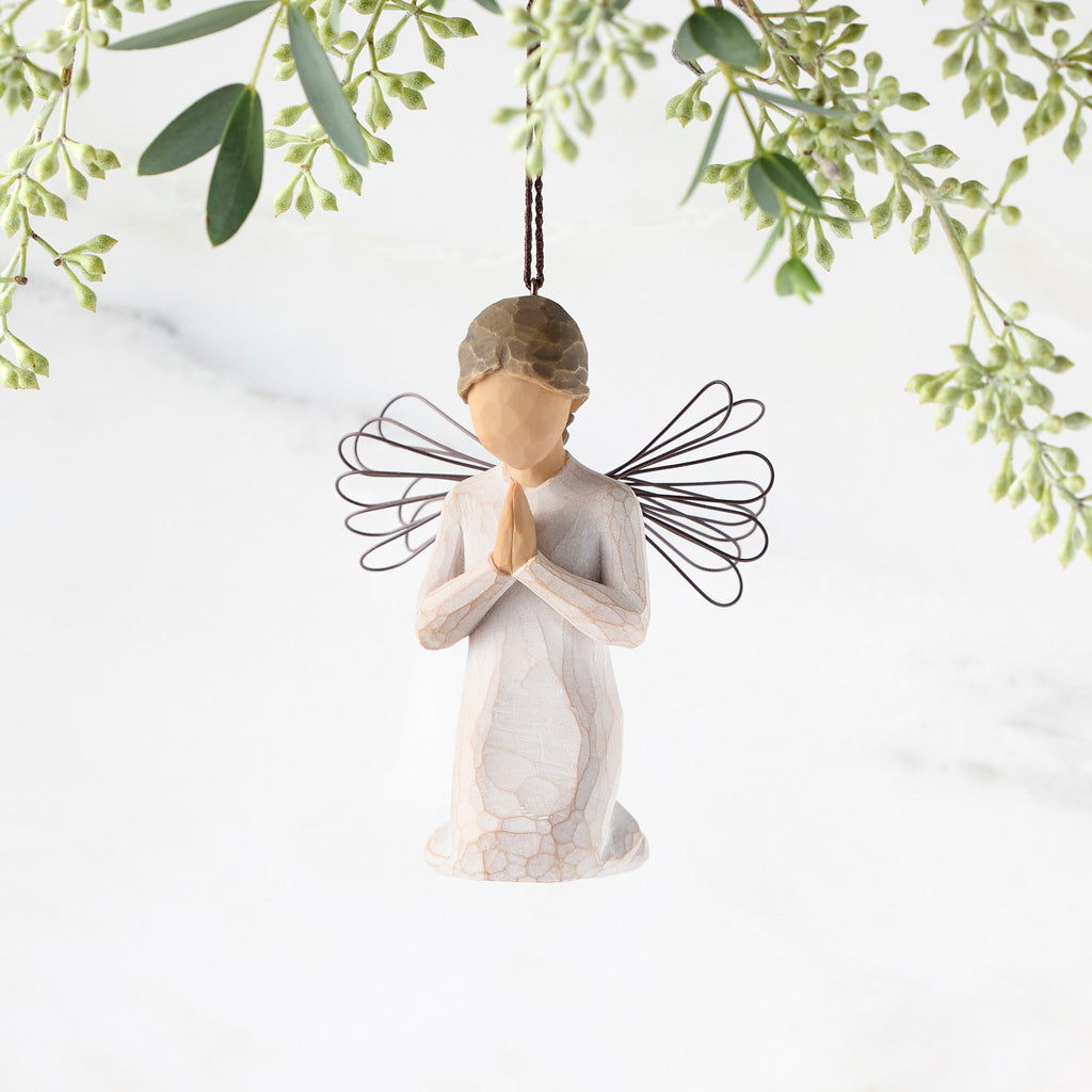 Figure of female angel in cream dress and wire wings, kneeling in prayer position, ornament loop on head