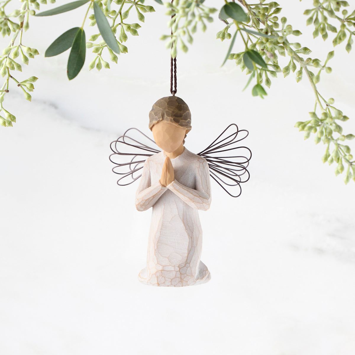 Figure of female angel in cream dress and wire wings, kneeling in prayer position, ornament loop on head