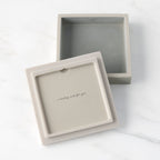 White resin box with detached lid showing sentiment on lid back; velvety gray-green finish in box base