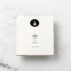 Back of white plaque reading piece title and sentiment, with Willow Tree logo