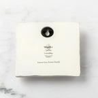 Back of white plaque reading piece title and sentiment, with Willow Tree logo