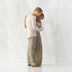 Right view of standing couple, woman has darker skin and hair; man has lighter skin and hair, holding a baby between them.