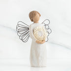 Front view of angel with short, light brown hair holding a metallic wreath of hearts with both hands
