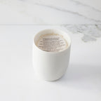 Top view of candle with vellum insert sheet with burning instructions