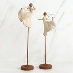Set of two angel figurines in white dresses danging on wooden stands