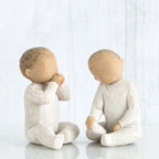Set of two faceless little children figurines - sitting down, wearing all white