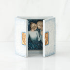 White/blue open box with two man and woman figurines inside holding hands