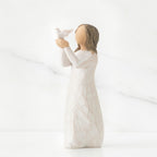 Faceless woman figurine in white dress holding up white bird in her arms