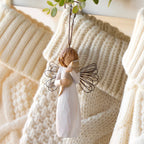 Willow Tree With affection Ornament, 4.5”h hand-painted resin figure in cream dress with wire wings, holding gray cat, brown elastic cord, hanging with cream knitted Christmas stockings