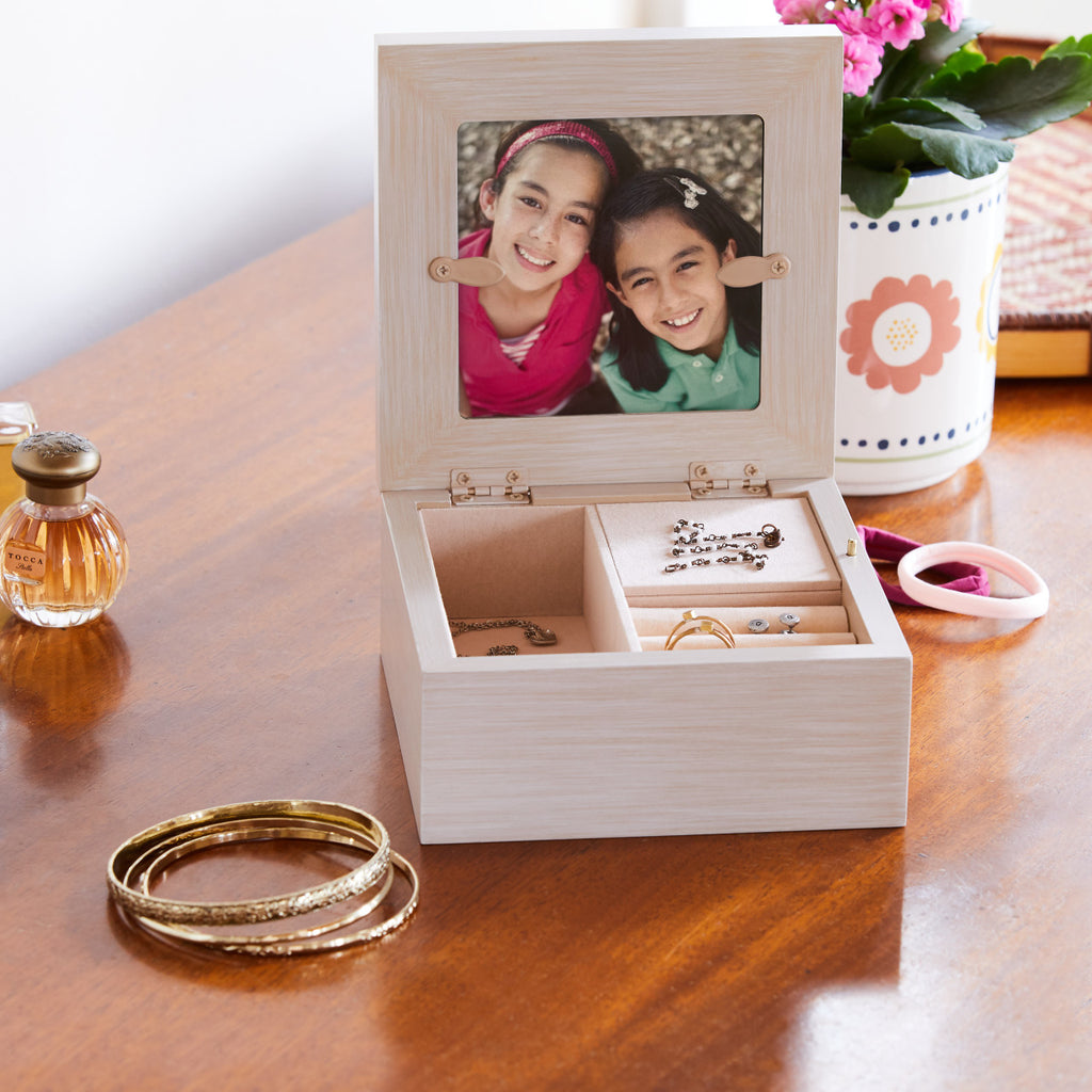 Willow Tree Friendship Music Jewelry Box, 5”sq x 2.5”h hand-painted cream wood box, open hinged lid has bas-relief resin carving of two seated figures in cream dresses, facing each other, 3.5”sq photograph fits inside lid, blush-colored fabric jewelry partitions inside